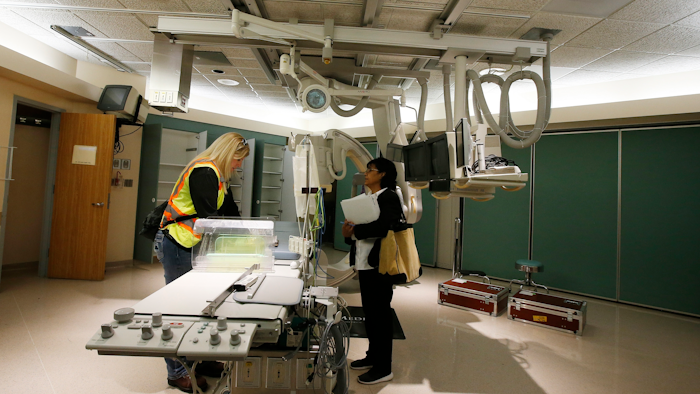 Mary Azelton, left, of the U.S. Army Corps of Engineers and Susie McCann from the Arizona Department of Health tour the closed St. Luke's Medical Center in Phoenix, March 25, 2020.
