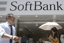 People walk by a SoftBank shop in Tokyo, Aug. 7, 2019.