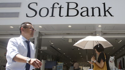 People walk by a SoftBank shop in Tokyo, Aug. 7, 2019.