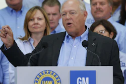 United Auto Workers President Dennis Williams speaks as General Motors CEO Mary Barra, background left, listens during a ceremony to mark the opening of contract negotiations in Detroit, July 13, 2015.