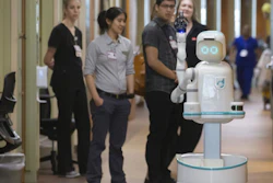 Hospital staff and representatives from Diligent Robotics watch Moxi, a medical assistant robot, at the University of Texas Medical Branch’s Jennie Sealy Hospital, Jan. 2019, Galveston, Texas.