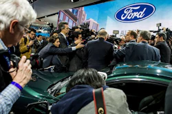 Members of the media interview Jim Hackett, president and CEO of Ford, in front the 2019 Mustang Bullitt at the North American International Auto Show, Jan. 14, 2018, in Detroit.