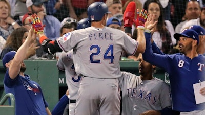 The Texas Rangers' Hunter Pence is congratulated after his inside the park home run against the Boston Red Sox at Fenway Park, June 11, 2019.