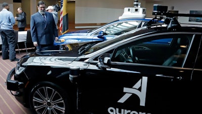 Pittsburgh Mayor William Peduto checks out autonomous vehicles designed by Aurora Innovations and Argo AI, March 4, 2019.