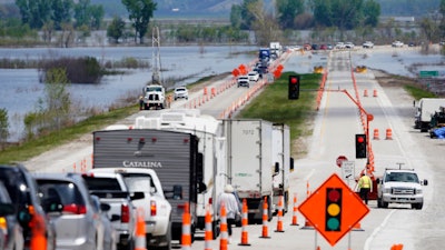 Vehicles await their turn to cross the single-lane bridge over the Missouri River on Highway 2 near Percival, Iowa, May 10, 2019.