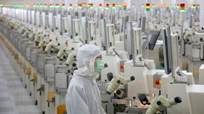 A worker at a microelectronics factory in Nantong, China, Feb. 20, 2020.