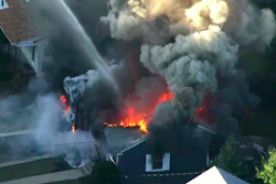 Flames consume the roof of a home following an explosion in Lawrence, Mass., Sept. 13, 2018.