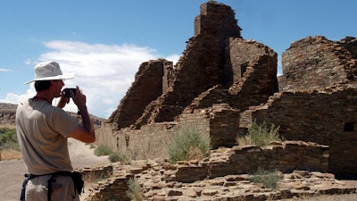 Chris Farthing of Suffolks County, England, takes a picture of Anasazi ruins in Chaco Culture National Historical Park in New Mexico, Aug. 10, 2005.