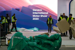 Workers dismantle a booth after the 90th Geneva International Motor Show is cancelled by Swiss authorities, Feb. 28, 2020.