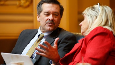 Del. Terry Kilgore R-Scott, left, talks with Del. Kathy Byron, R-Bedford, during a House session at the Capitol, Feb. 28, 2020, in Richmond, Va.