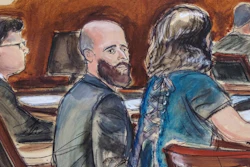 In this courtroom sketch, Joshua Schulte, center, is seated at the defense table flanked by his attorneys during jury deliberations, March 4, 2020, in New York.