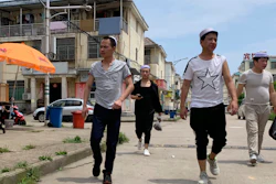 Residents of the Hui Muslim ethnic minority walk in a neighborhood near an OFILM factory in Nanchang, China, June 5, 2019.