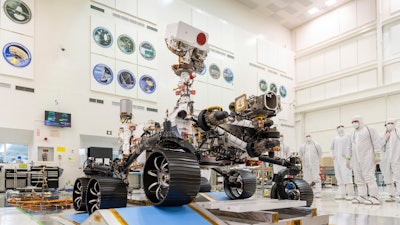 Engineers watch the first driving test for the Mars 2020 rover in a clean room at the Jet Propulsion Laboratory in Pasadena, Calif., Dec. 17, 2019.