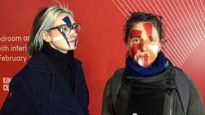 Artists Georgina Rowlands, left, and Anna Hart pose for a photo with their faces painted, Feb. 17, 2020.