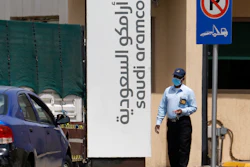 A security person wears a mask as he checks vehicles entering a compound for Saudi Aramco in Jiddah, Saudi Arabia, March 9, 2020.