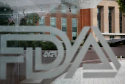 The U.S. Food and Drug Administration building behind FDA logos at a bus stop in Silver Spring, Md., Aug. 2, 2018.