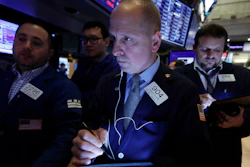 Trader Michael Urkonis, center, works on the floor of the New York Stock Exchange, March 10, 2020.