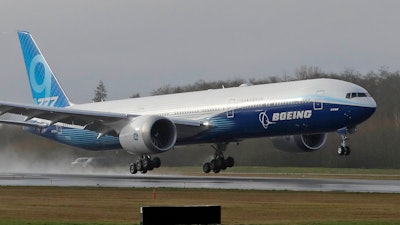 A Boeing 777X airplane takes off on its first flight at Paine Field in Everett, Wash., Jan. 25, 2020.