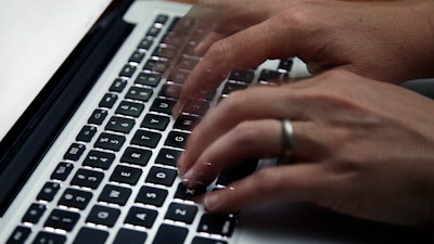 A person working on a laptop in North Andover, Mass., June 19, 2017.