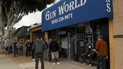 Gun store patrons wait in line in Burbank, Calif., March 15, 2020.