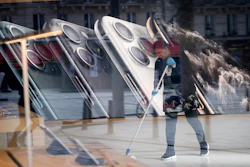 A worker cleans the Apple Store on the Champs-Elysees avenue in Paris, March 15, 2020.