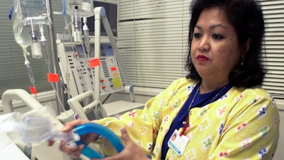 Lovely R. Suanino, a respiratory therapist at Newark Beth Israel Medical Center in Newark, N.J., demonstrates setting up a ventilator, May 25, 2005.