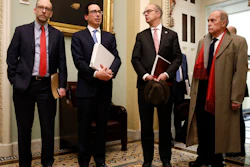 Treasury Secretary Steve Mnuchin, second from left, speaks as he departs a meeting with Senate Republicans on Capitol Hill, March 16, 2020.