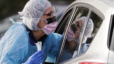 Laurie Kuypers, a registered nurse, at a drive-through COVID-19 testing station in Seattle, March 17, 2020.