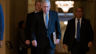Senate Majority Leader Mitch McConnell, R-Ky., walks to the chamber at the Capitol, March 18, 2020.