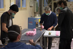 Serge Bruna, center, and soap artisans cut bars of soap at the Licorne factory in Marseille, France, March 16, 2020.