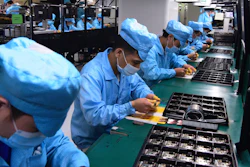 Workers wear masks at a factory for telecom company OPPO in Dongguan, China, Feb. 13, 2020.