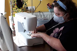 Sien Lagae works on a mouth mask on her sewing machine in Torhout, Belgium, March 19, 2020.