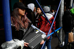 Anna Louisa, 18, receives a laptop for home study at the Lower East Side Preparatory School in New York, March 19, 2020.