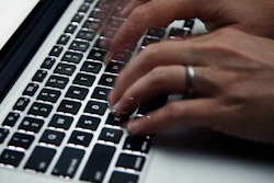 A person working on a laptop in North Andover, Mass., June 19, 2017.