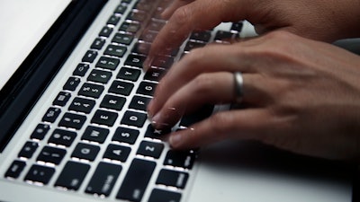 A person working on a laptop in North Andover, Mass., June 19, 2017.