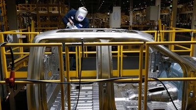 Ron Hudgins welds a 2015 Ford F-150 cab at the Dearborn Truck Plant, Dearborn, Mich., Nov. 11, 2014.