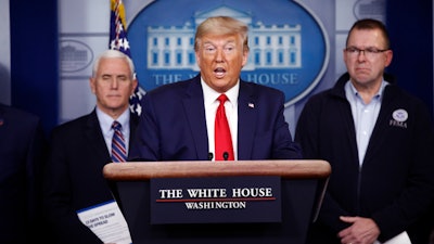 President Donald Trump speaks as Vice President Mike Pence, left, and FEMA Administrator Peter Gaynor look on during a coronavirus task force briefing at the White House, March 22, 2020.