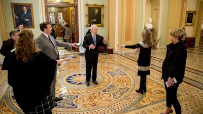 Senate Majority Leader Mitch McConnell speaks to reporters outside the Senate chamber, March 23, 2020.