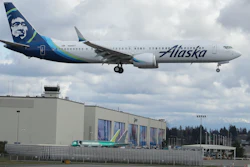 An Alaska Airlines Boeing 737-9 Max flies over Boeing's manufacturing facility in Everett, Wash., March 23, 2020.