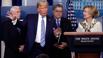 President Donald Trump gestures during a briefing about the coronavirus in the James Brady Briefing Room, March 23, 2020, in Washington.