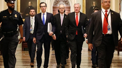 Treasury Secretary Steven Mnuchin, left, White House Legislative Affairs Director Eric Ueland and acting White House chief of staff Mark Meadows on Capitol Hill, March 24, 2020.