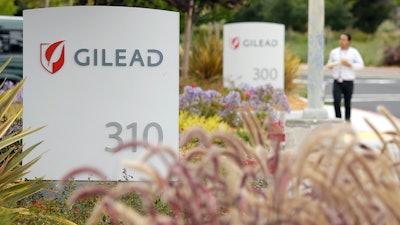 A man walks outside the headquarters of Gilead Sciences in Foster City, Calif., July 9, 2015.