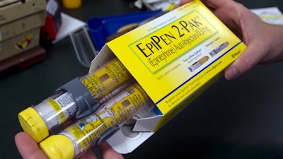 A pharmacist holds a package of EpiPens in Sacramento, Calif., July 8, 2016.
