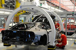 A technician works at the Ferrari department factory in Maranello, Italy, May 8, 2013.