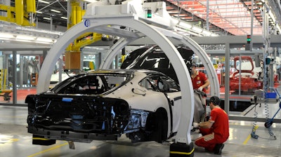 A technician works at the Ferrari department factory in Maranello, Italy, May 8, 2013.