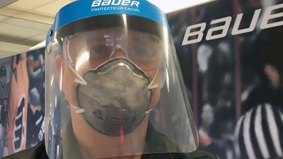 A Bauer employee models a medical face shield, Blainville, Quebec, March 23, 2020.
