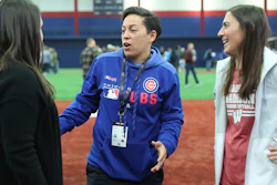 Chicago Cubs minor league hitting coach Rachel Folden, center, talks with colleagues during a hitting clinic at the University of Illinois-Chicago, Nov. 23, 2019.