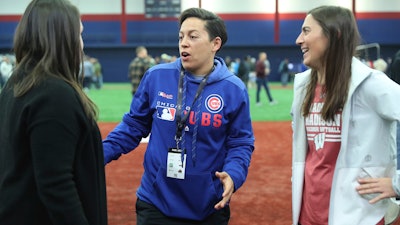 Chicago Cubs minor league hitting coach Rachel Folden, center, talks with colleagues during a hitting clinic at the University of Illinois-Chicago, Nov. 23, 2019.