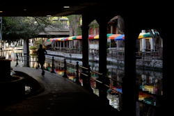 A runner along the mostly deserted River Walk in San Antonio, March 24, 2020.