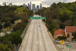 Light traffic moves along the 110 Harbor Freeway toward downtown Los Angeles, March 20, 2020.